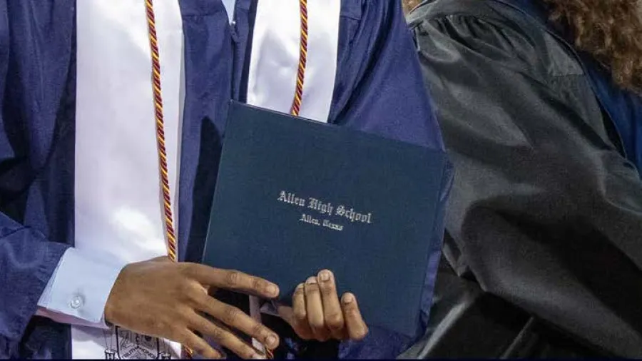 A graduate holding a diploma from Allen ISD