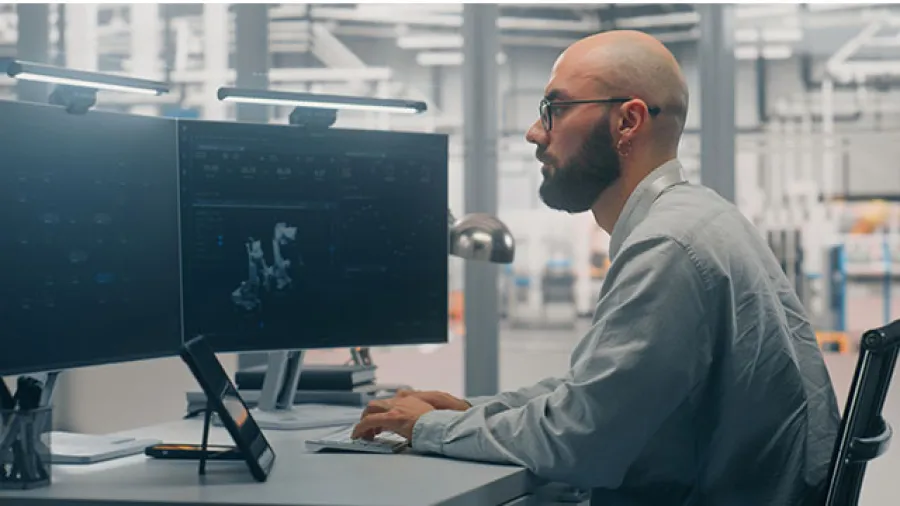 Man working at a computer analyzing data.
